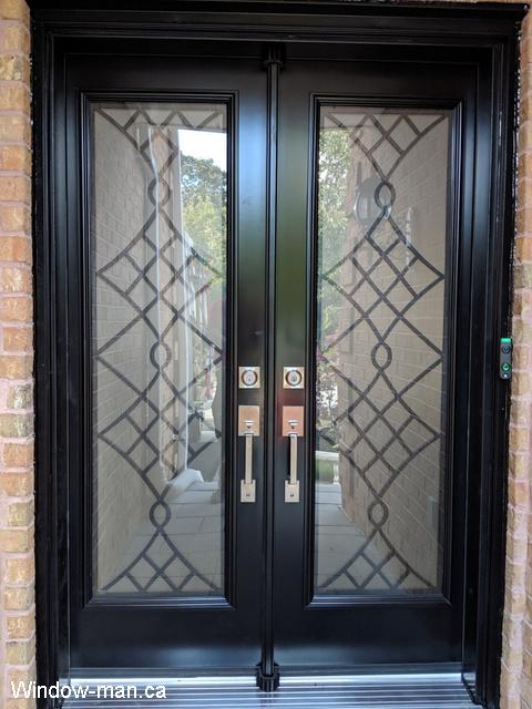 Double insulated steel front entry door custom size. Very narrow 56 inches door, 28 each slab. Black. Contemporary Oak Ridge wrought iron glass inserts